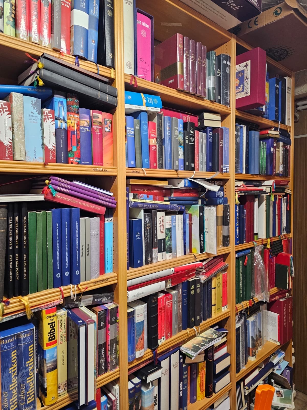 Nahaufnahme eines Regals mit Büchern von Anselm Grün und weiteren Autoren